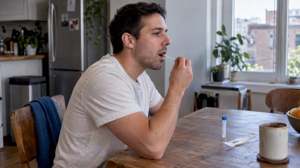 Person collecting a saliva test sample